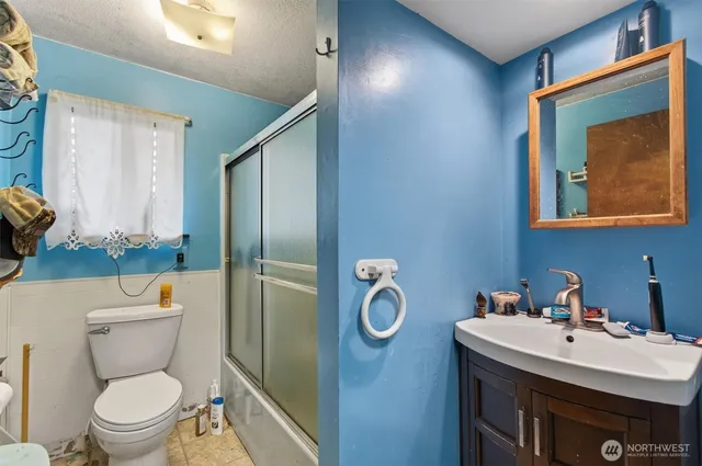 a bathroom with a toilet sink and mirror