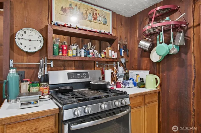 a stove top oven sitting inside of a kitchen