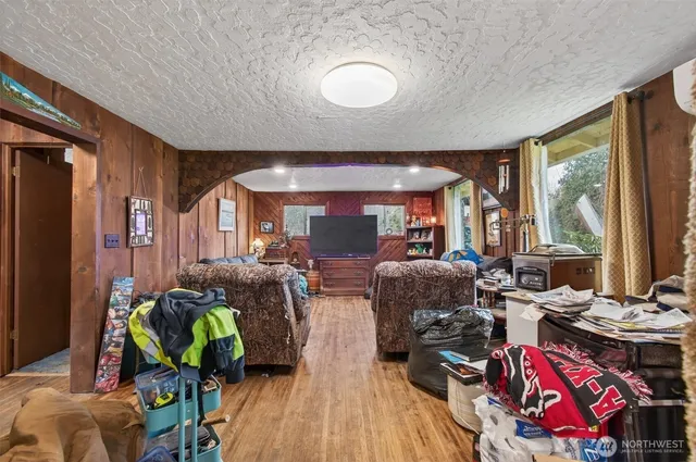a living room with furniture and a floor to ceiling window