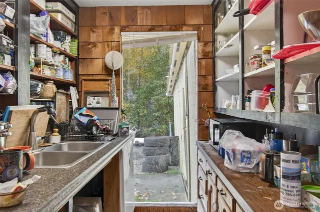 a kitchen with a sink and a stove top oven