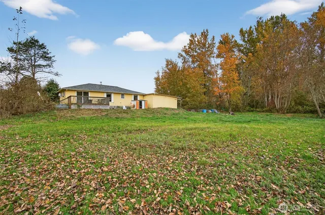 a large yard with lots of green space and trees all around