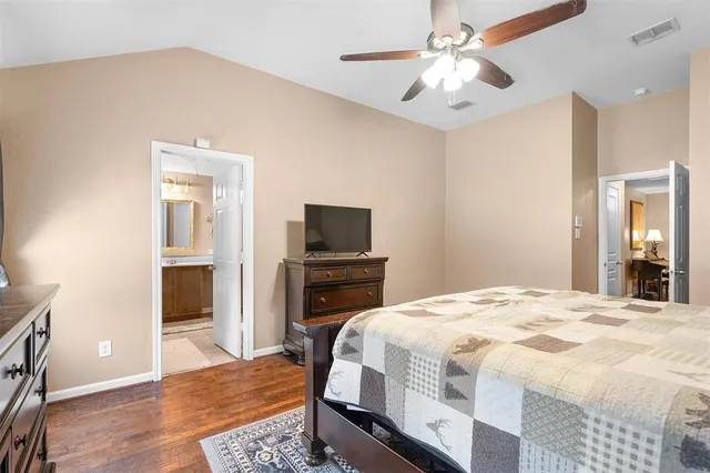 a bedroom with a bed and a television