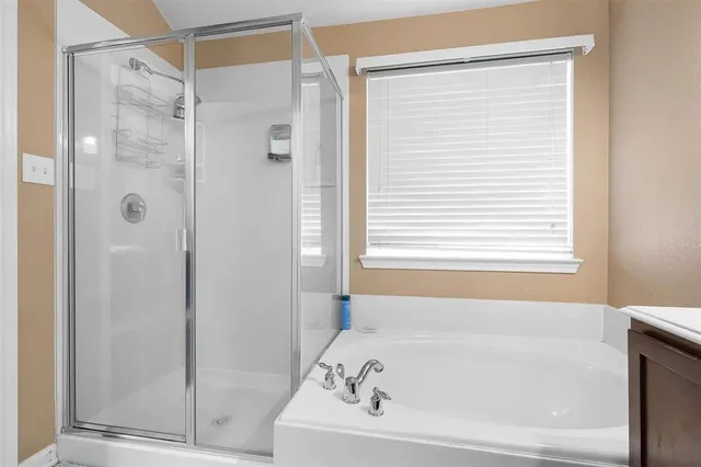 a bathroom with a bathtub and a shower