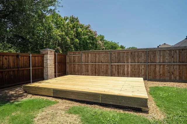 a view of a backyard with a wooden fence