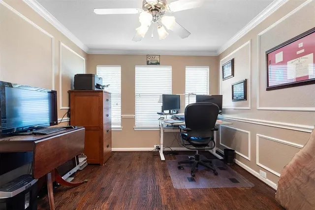a view of a workspace with furniture and a window