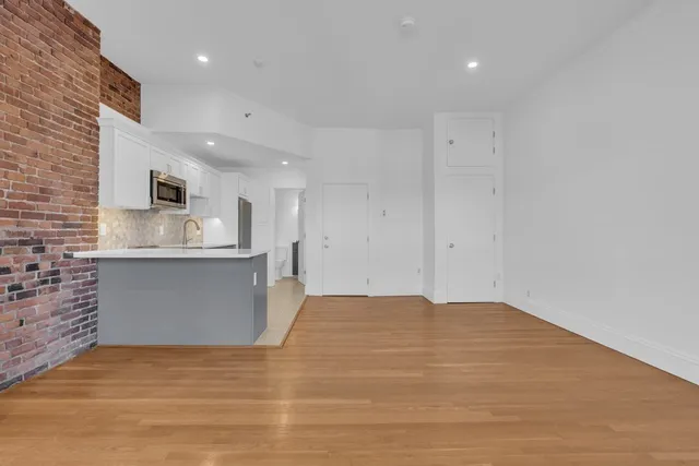 a view of kitchen with granite countertop cabinets and sink