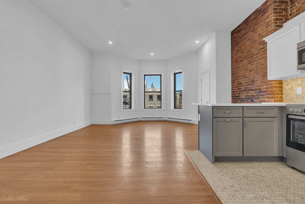 389 Beacon Street, Unit 7 Boston, MA 02116 - Photo 6 of 12 a view of a kitchen with a sink cabinets and window