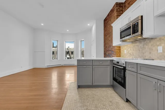 a kitchen with stainless steel appliances granite countertop a stove and a sink