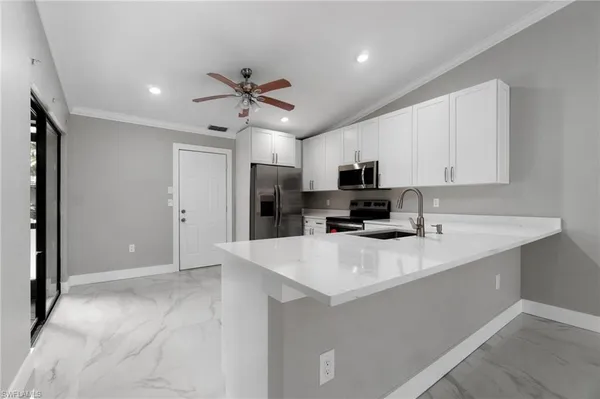 a kitchen with stainless steel appliances a refrigerator stove microwave and cabinets