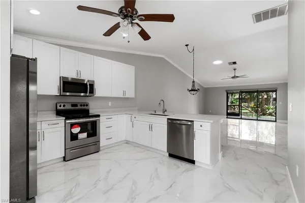 a kitchen with a sink stainless steel appliances and cabinets