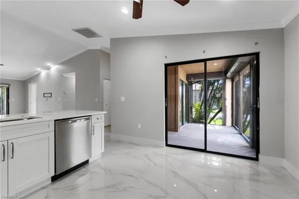 a kitchen with white cabinets and center island