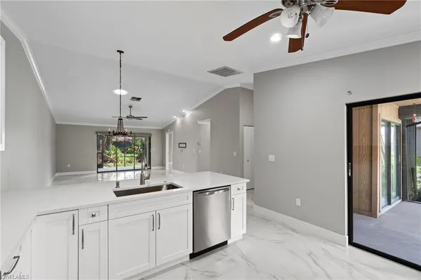 a view of a livingroom with a ceiling fan and window