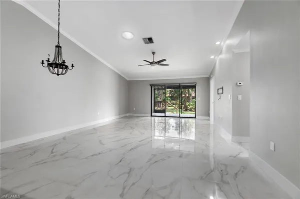 a large kitchen with granite countertop a large counter top a sink stainless steel appliances and cabinets