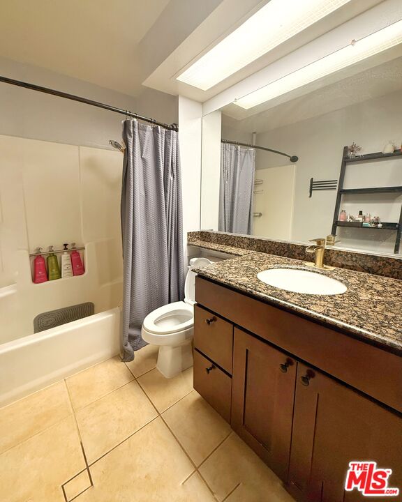 1118 Valencia Street, Unit 320 Los Angeles, CA 90015 - Photo 16 of 24 a bathroom with a granite countertop sink toilet and shower