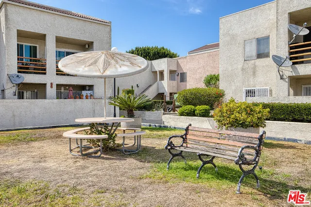 a backyard of a house with table and chairs