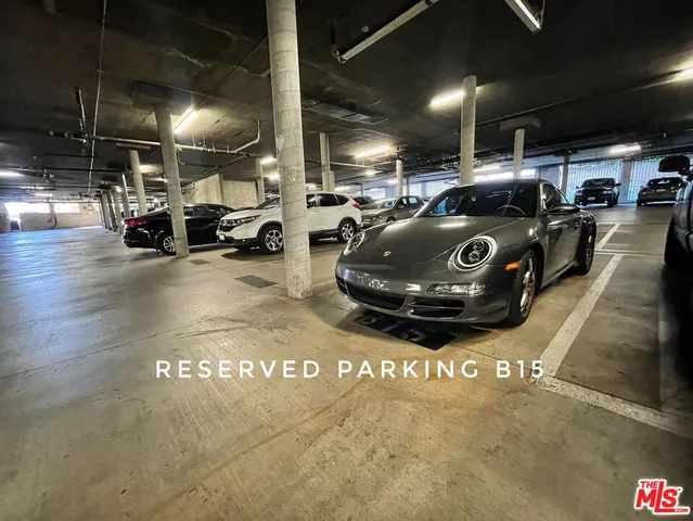 a view of parking garage with cars parked