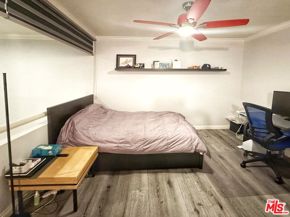 1118 Valencia Street, Unit 320 Los Angeles, CA 90015 - Photo 8 of 24 a bedroom with a bed and a chandelier