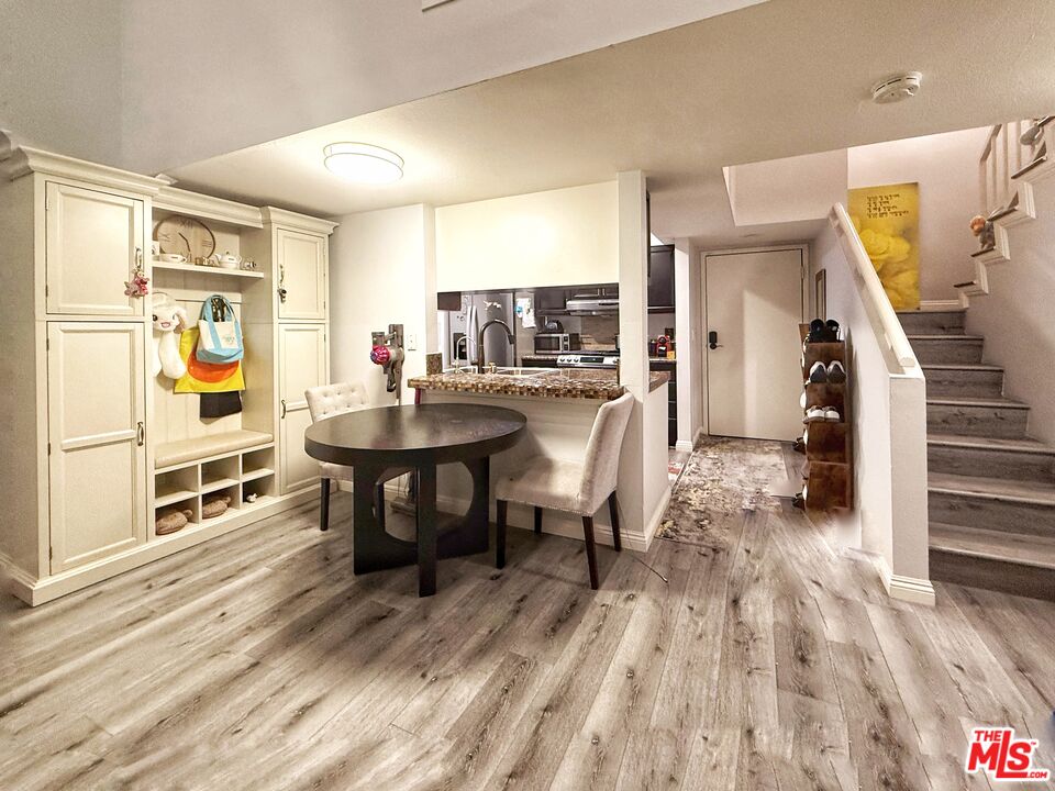 1118 Valencia Street, Unit 320 Los Angeles, CA 90015 - Photo 10 of 24 a dining room with furniture and wooden floor