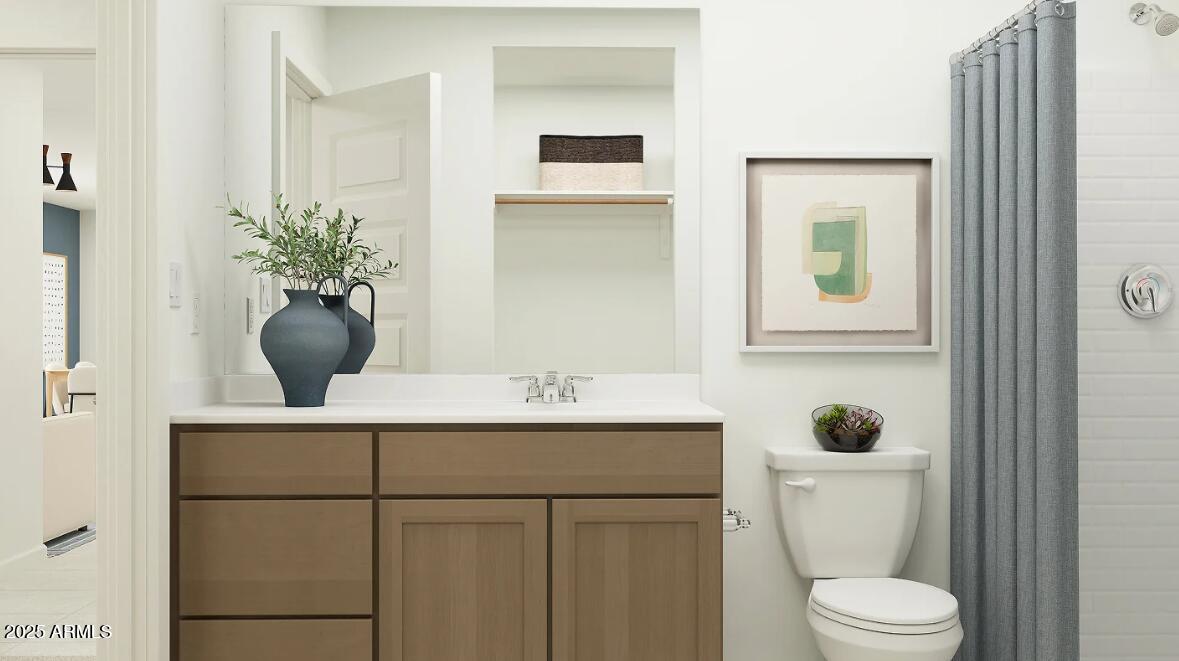 9552 West Piccadilly Road Phoenix, AZ 85037 - Photo 10 of 19 a bathroom with a toilet a sink and mirror