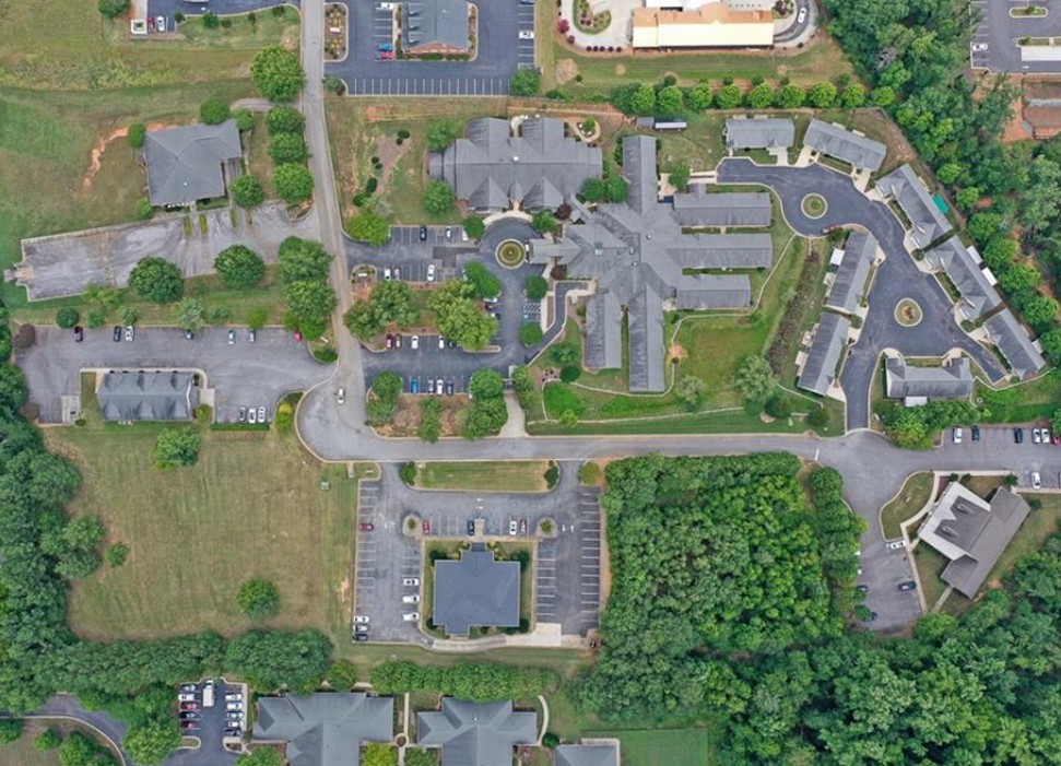 120 Perpetual Square Drive Anderson, SC 29621 - Photo 9 of 14 An aerial perspective showcases the community layout with buildings nestled amongst lush greenery and ample parking.
