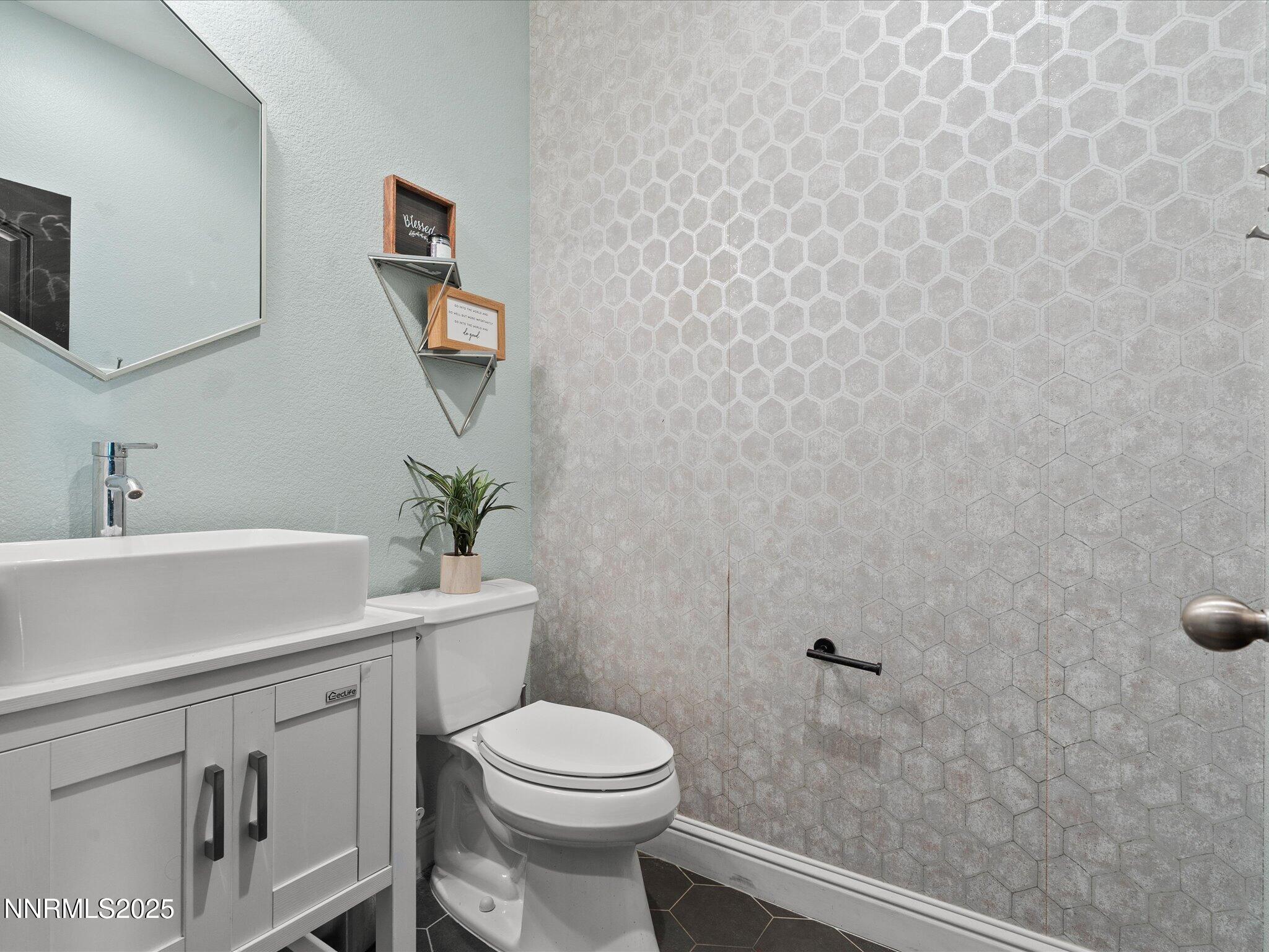 2135 Horse Prairie Road Reno, NV 89521 - Photo 12 of 32 a bathroom with a toilet a sink and mirror