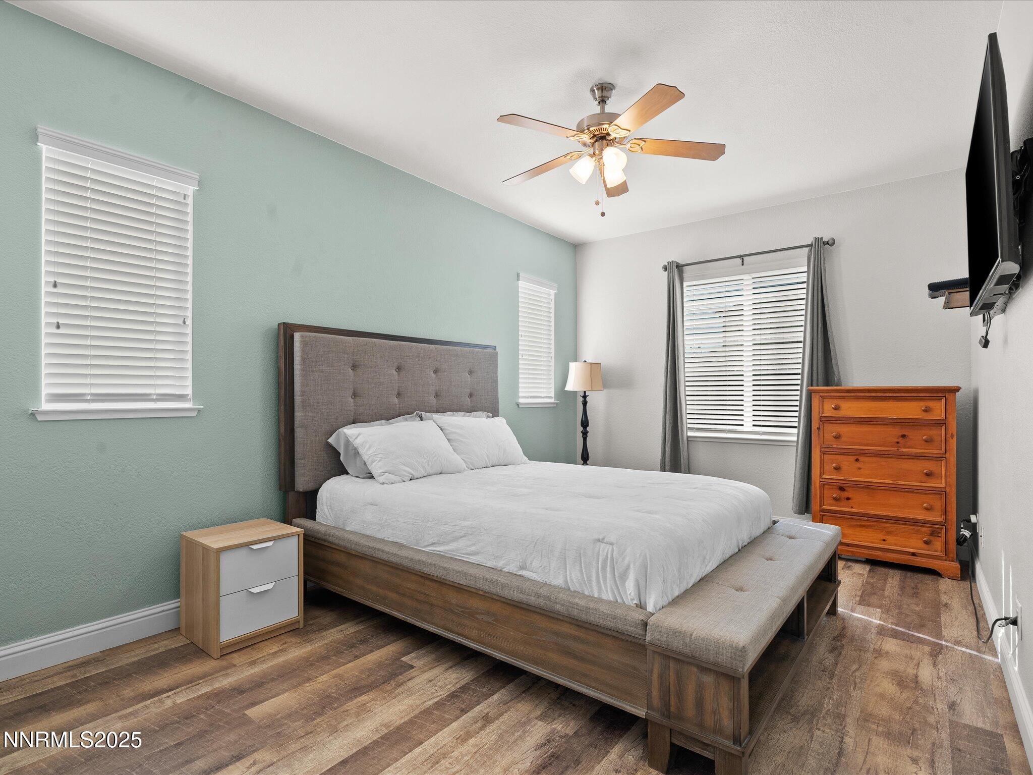 2135 Horse Prairie Road Reno, NV 89521 - Photo 13 of 32 a bedroom with a bed and a chandelier