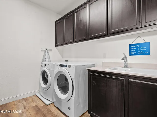 a utility room with sink dryer and washer