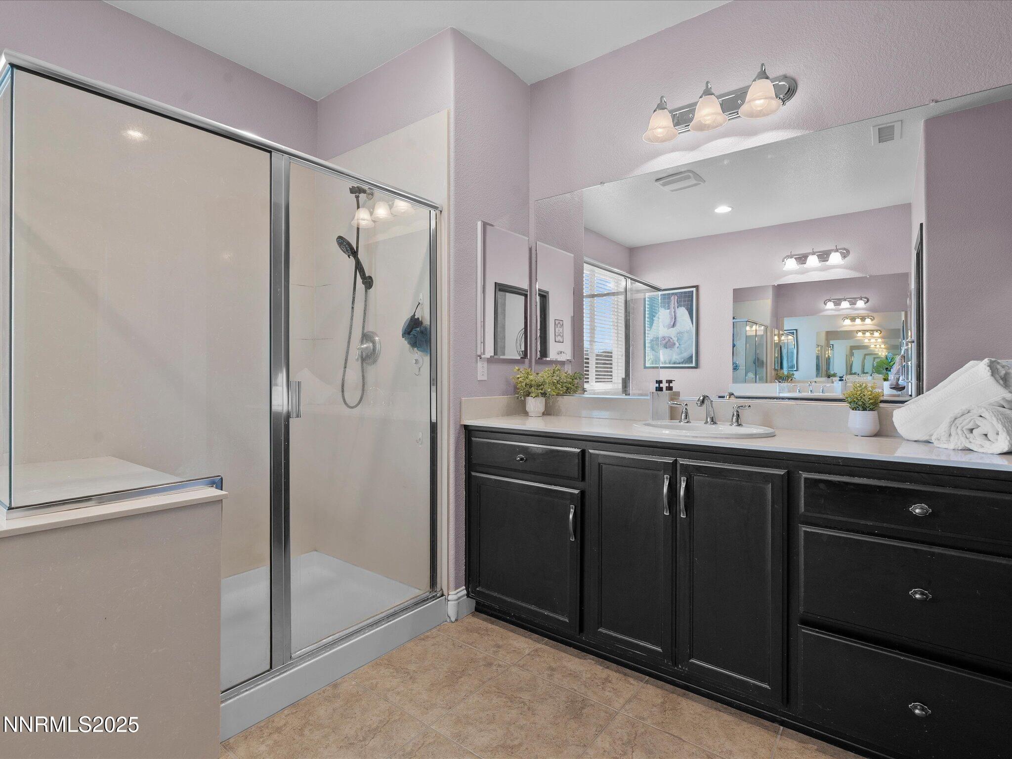 2135 Horse Prairie Road Reno, NV 89521 - Photo 22 of 32 a bathroom with a double vanity sink mirror and shower