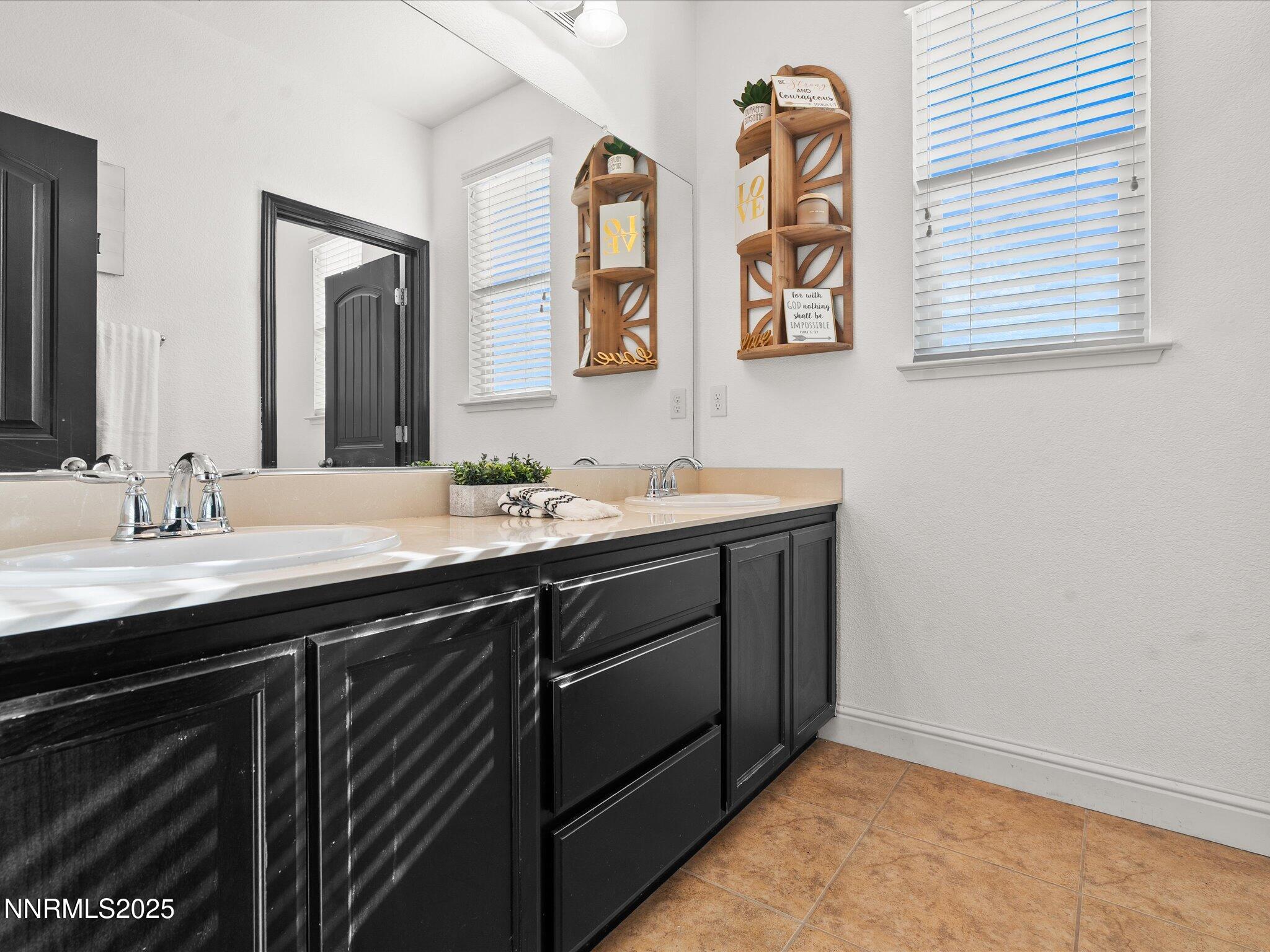 2135 Horse Prairie Road Reno, NV 89521 - Photo 25 of 32 a bathroom with a double vanity sink and a mirror