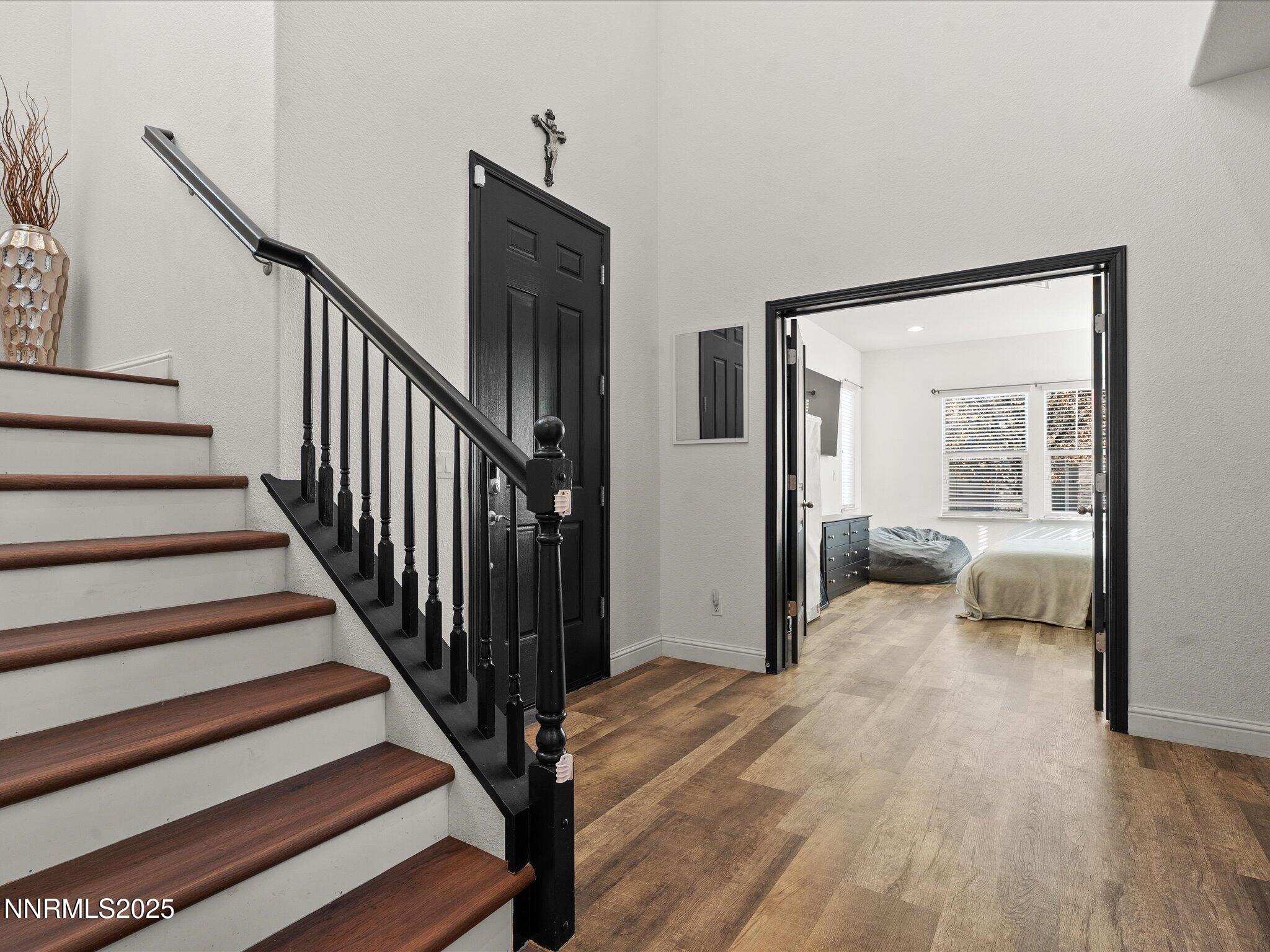 2135 Horse Prairie Road Reno, NV 89521 - Photo 4 of 32 a view of a hallway with wooden floor and staircase