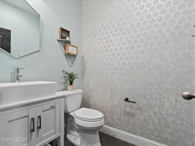 a bathroom with a toilet a sink and mirror