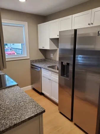 a kitchen with stainless steel appliances granite countertop a refrigerator sink and stove