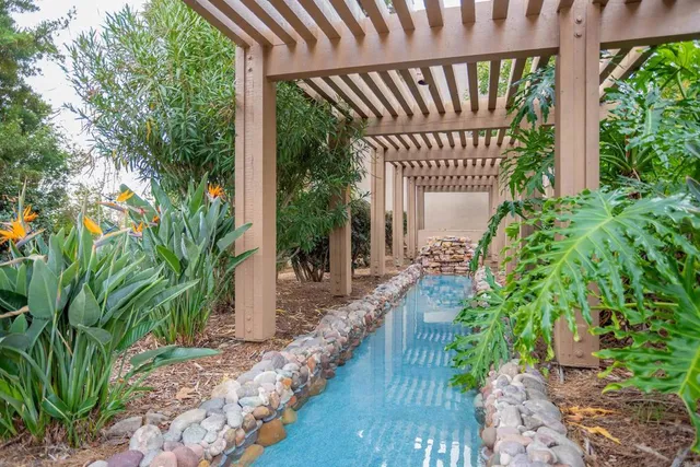 a house with lots of trees in front of it