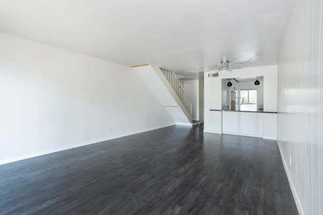 wooden floor in an empty room with a mirror