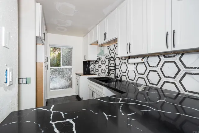 a kitchen with a sink and cabinets
