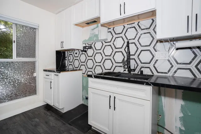 a kitchen with a stove and a white cabinet