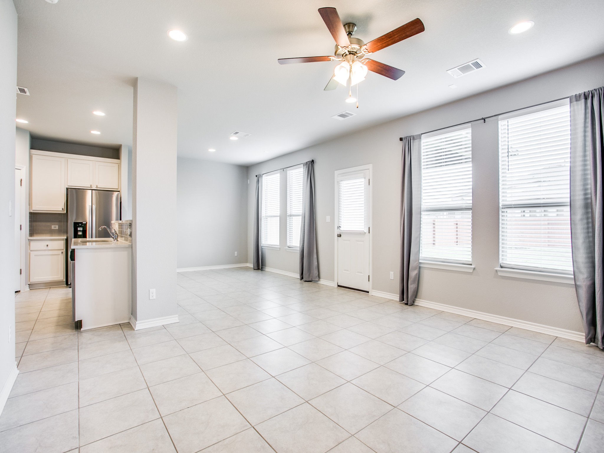 508 Rearing Mare Pass Georgetown, TX 78626 - Photo 3 of 26 Open entertaining rooms with ceiling fan, recessed lighting, baseboards, and light tile patterned floors