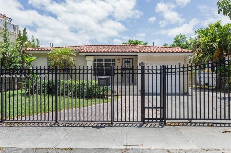 a view of a wrought iron fences in front of house
