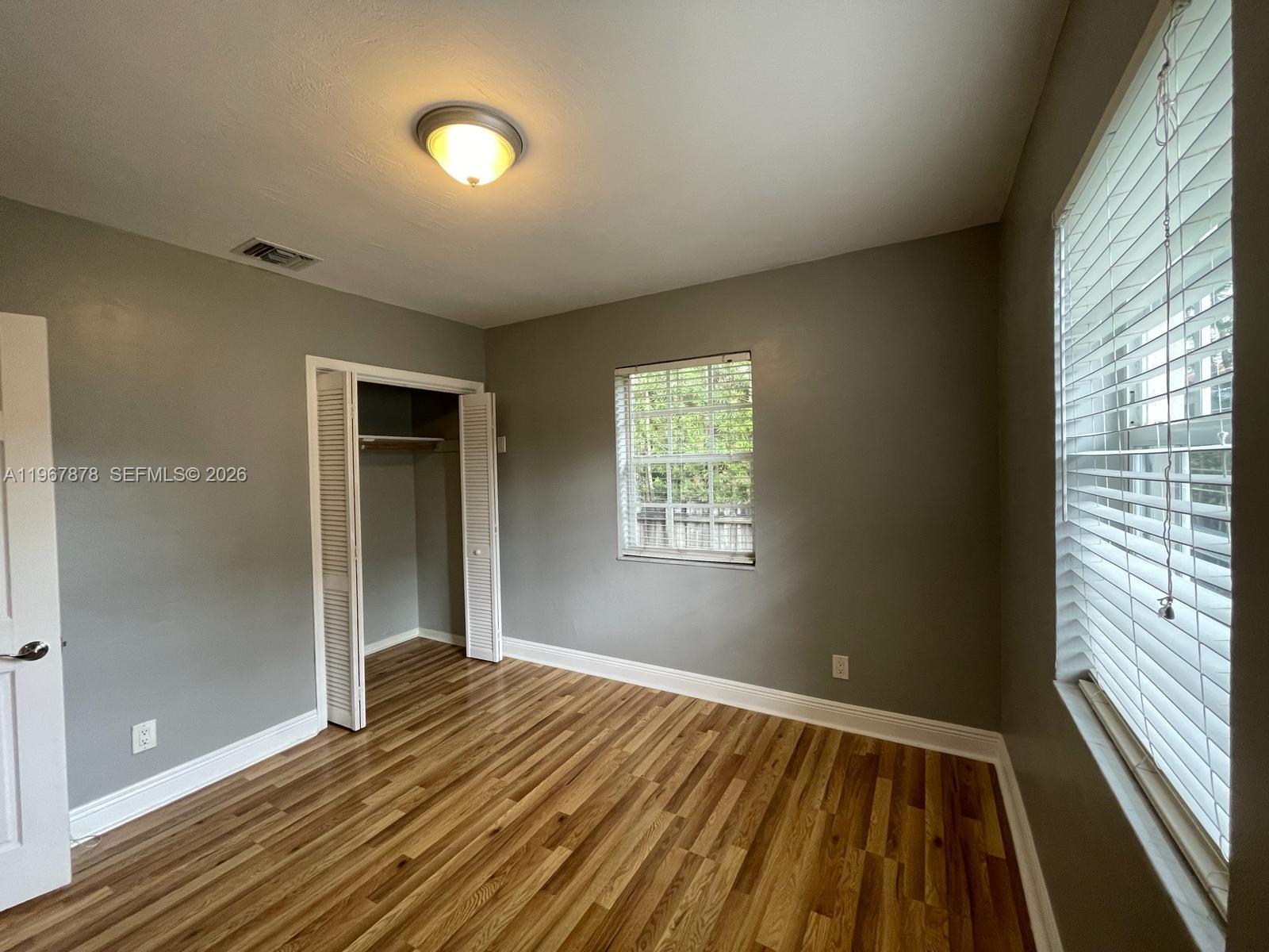 3350 Southwest 29th Street Miami, FL 33133 - Photo 13 of 15 a view of an empty room with wooden floor and a window