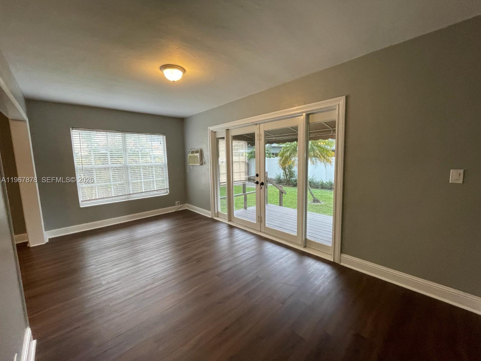 3350 Southwest 29th Street Miami, FL 33133 - Photo 6 of 15 a view of an empty room with wooden floor and a window