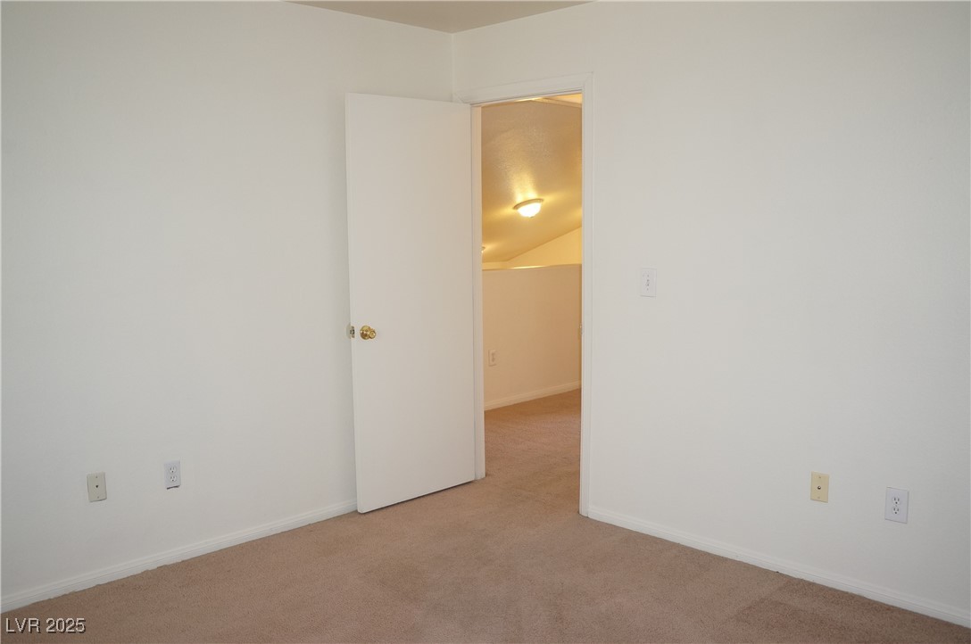 6148 Bluehill Avenue, Unit 2 Las Vegas, NV 89156 - Photo 12 of 13 Unfurnished room with carpet floors and baseboards