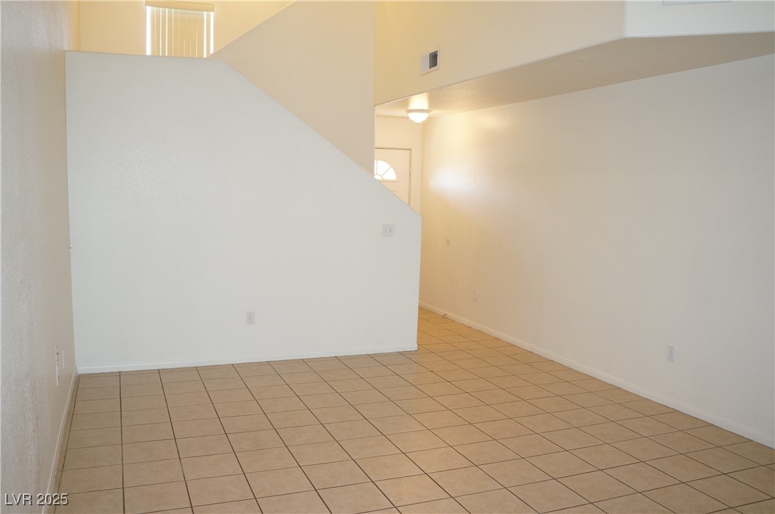 6148 Bluehill Avenue, Unit 2 Las Vegas, NV 89156 - Photo 3 of 13 Unfurnished room with light tile patterned flooring
