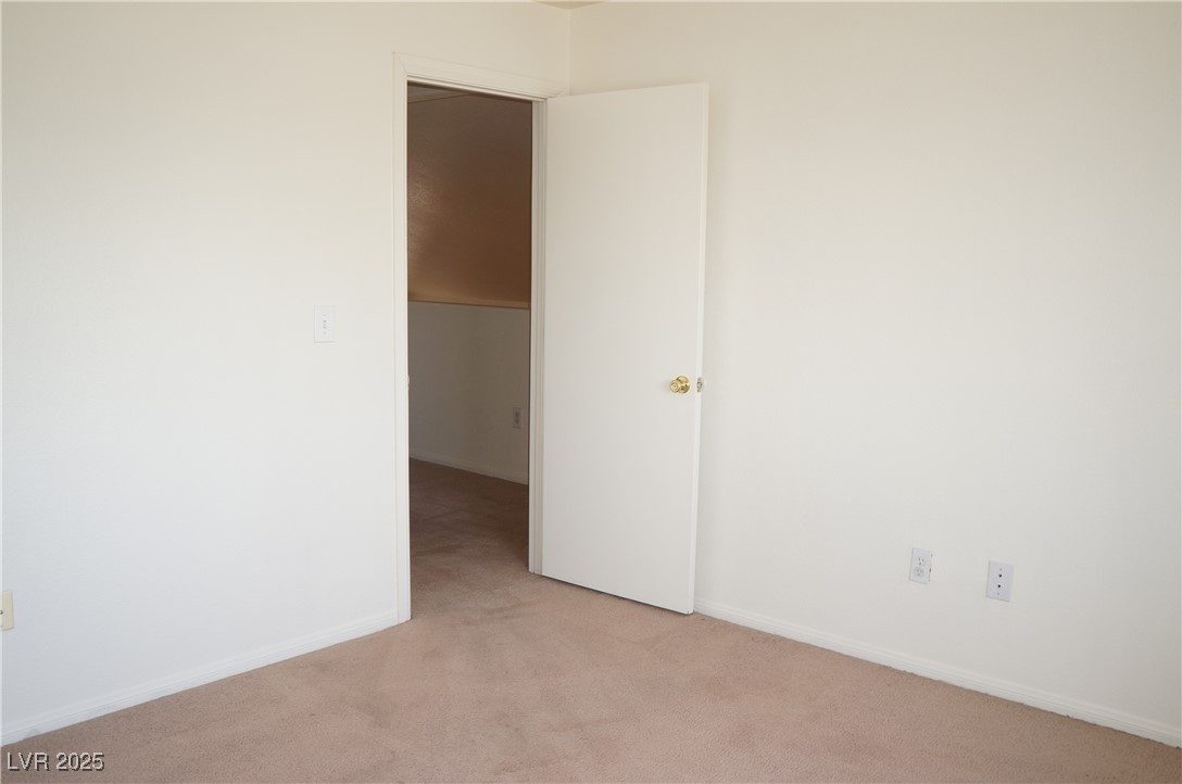 6148 Bluehill Avenue, Unit 2 Las Vegas, NV 89156 - Photo 7 of 13 Carpeted empty room featuring baseboards