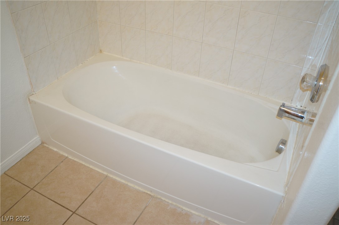 6148 Bluehill Avenue, Unit 2 Las Vegas, NV 89156 - Photo 9 of 13 Bathroom with tile patterned flooring and a bathtub