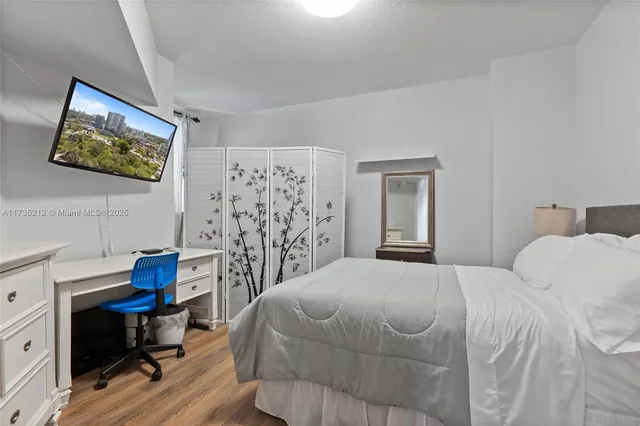 a bedroom with a bed and a desk