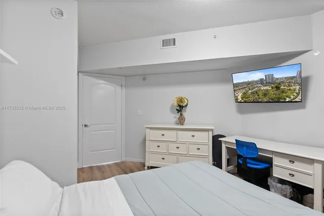 a bedroom with a bed and ceiling fan