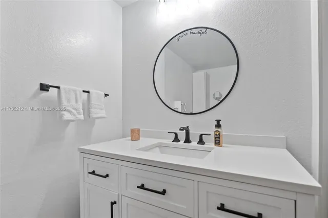 a bathroom with a sink a and a mirror