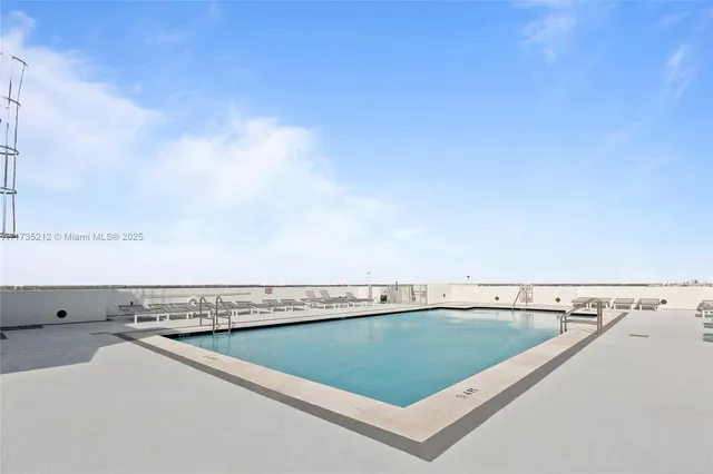 a view of a swimming pool and an outdoor seating