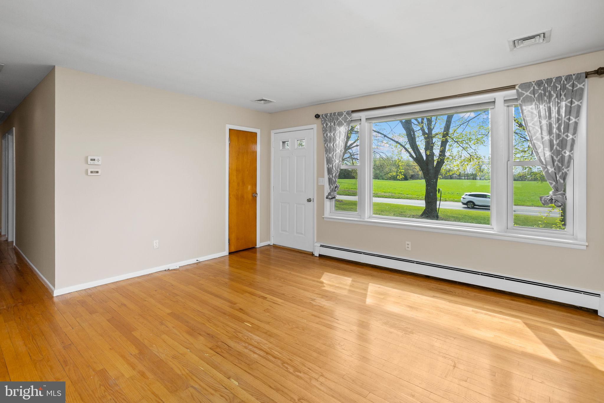892 Monmouth Road Cream Ridge, NJ 08514 - Photo 4 of 24 a view of an empty room with a window