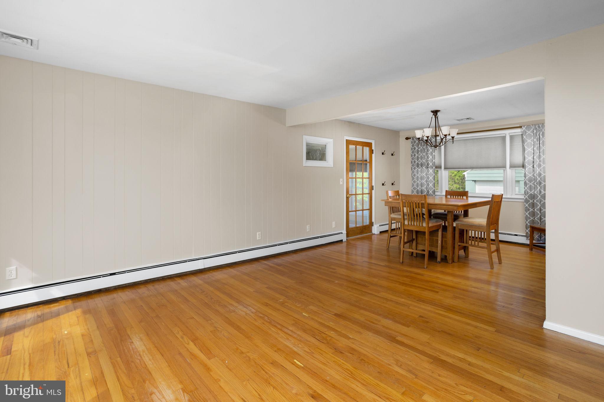 892 Monmouth Road Cream Ridge, NJ 08514 - Photo 5 of 24 a view of a dining room with furniture and wooden floor